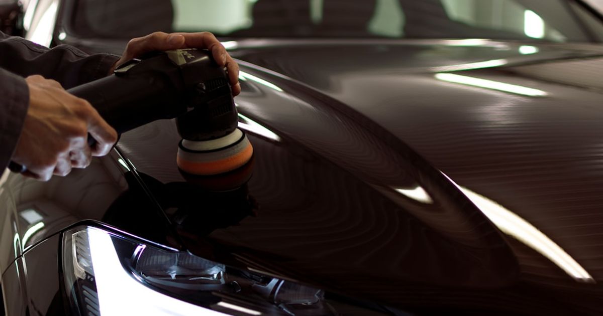 Hand waxing a freshly washed vehicle